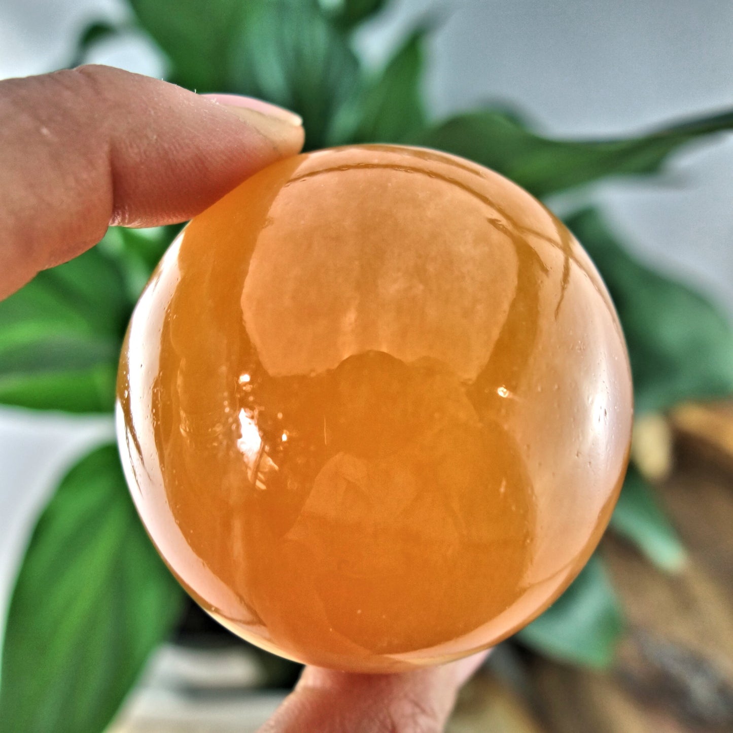 Juicy Orange Calcite Sphere Carving - Earth Family Crystals